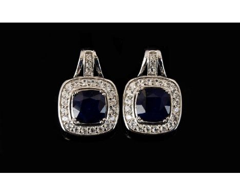 Sapphire and Natural White Zircon Drop Earrings, with ruby accents; each earring comprising a square cushion cut sapphire of 