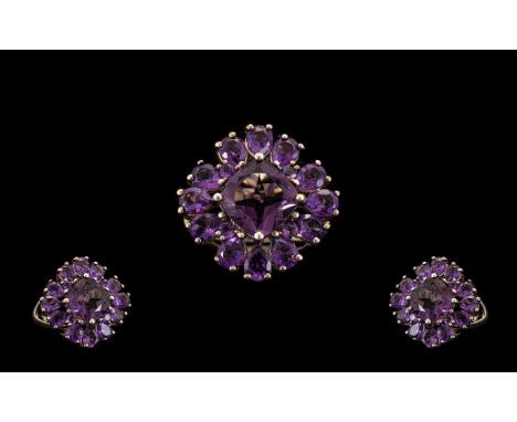 Amethyst Cluster Ring, a square cut amethyst of 2cts, set on the diagonal, with three pear cut matching amethysts framing eac