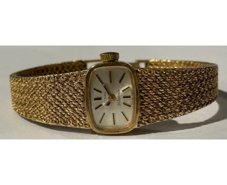 A lady's Rotary 9ct gold watch, rounded rectangular silvered dial, baton indicators, integral 9ct gold bracelet strap, 28.9g,