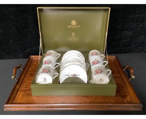 A Royal Worcester coffee set for six, printed with a spray of summer flowers, boxed; a mahogany two handled rounded rectangul