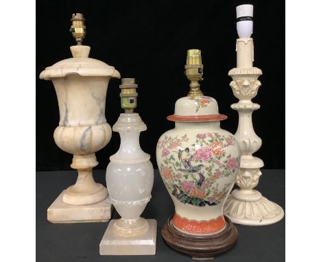 A large alabaster urn table lamp; another, similar, smaller; a carved wooden lamp; a Chinese vase lamp (4) 