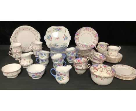 An Aynsley tea service for six, decorated with stylised pink and blue flowers, comprising cake plate, side plates, sugar bowl