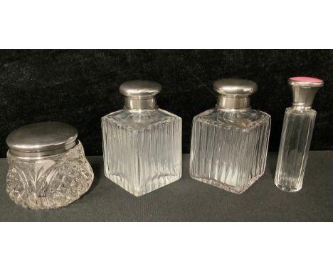 A pair of early George V clear glass facetted square scent bottles, domed silver covers, clear glass drop-in stoppers, 8cm Ge