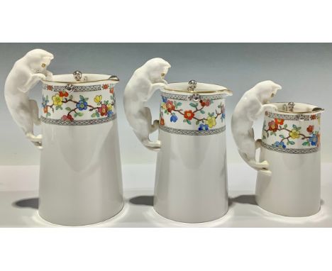 A graduating set of three Spode Copeland's China milk jugs, the handles modelled as cats, each with glass eyes, plated swing 