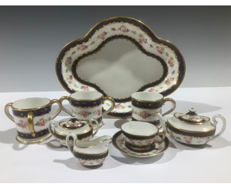 A Royal Crown Derby miniature tea service, decorated with flowers within cobalt blue borders, picked out in gilt, comprising 