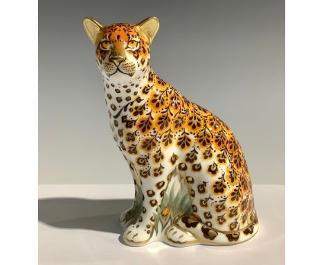 A Royal Crown Derby paperweight, Leopardess, 13cm high, silver stopper and red printed marks to the base 