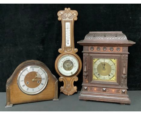 An early 20th century bracket style mantel clock, silvered dial, Roman numerals, twin winding holes; 40cm; an oak aneroid whe