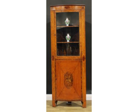 A Sheraton Revival satinwood and marquetry floor-standing bowfront corner display cabinet, moulded cornice above a glazed doo