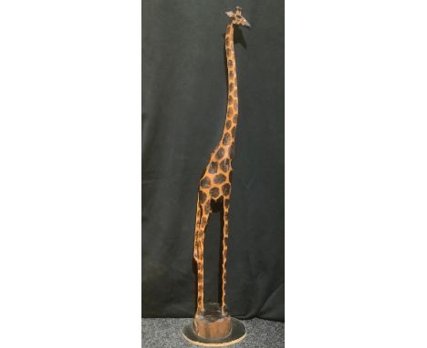 An African carved and poker work wooden giraffe model, stylised long slender neck and legs, floor standing, plinth base, 143c