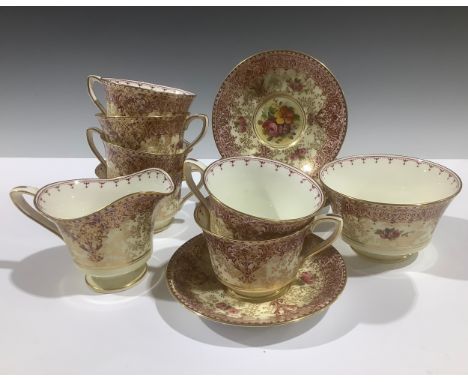 A Royal Worcester tea service for six, printed and painted with colourful flowers on a cream ground, burgundy geometric flora