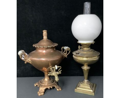 A Victorian copper samovar, two handled, brass tap, quatrefoil base with paw feet, 44cm; a brass oil lamp, twin burner, opaqu