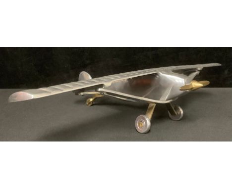 An aluminium desk model of Charles Lindbergh's Spirit of St. Louis monoplane in which he made the first solo non-stop crossin