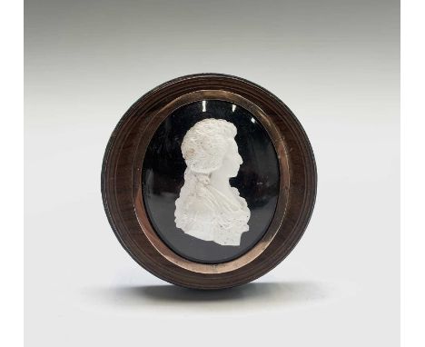 An 18th-century white relief portrait possibly Marie Antoinette mounted on a base taille purple ground beneath convex oval gl
