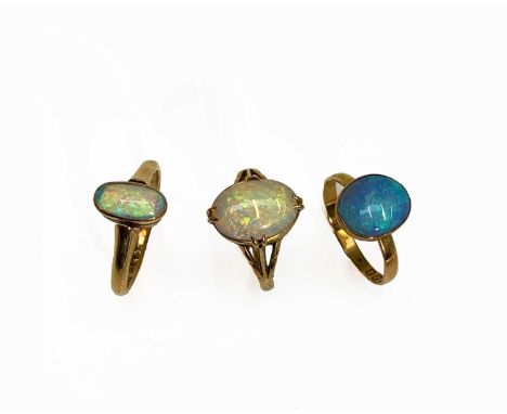 Three gold rings each with an oval opal 7.9gmCondition report: Approx sizes, largest stone first:L, L-M &amp; O-P (smallest s