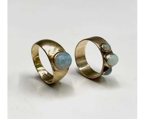 An 18ct gold ring collet set with an opal 6.1gm and a gold ring collet set with three opals 3gmCondition report: The opal in 