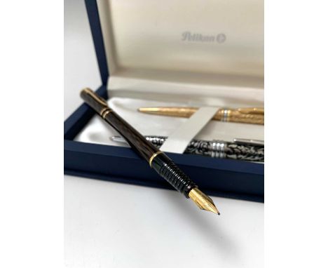 A Waterman Laureat Shadowed Amber fountain pen and matching rollerball pen together with two Pelikan ballpoint pens, cased