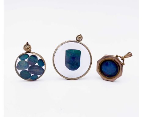 Three gold-mounted pendants, each containing opal behind glass 19.3gm