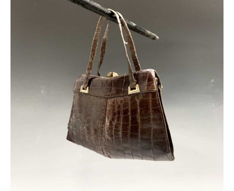 A crocodile handbag and a cigarette case with cigarettes