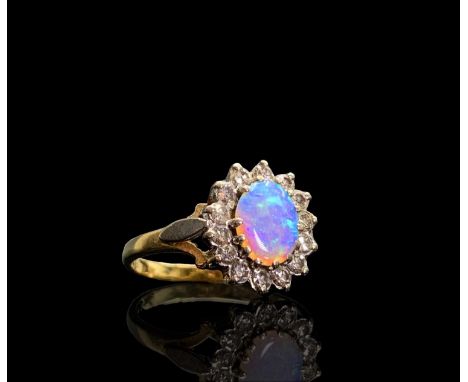 An opal and diamond oval cluster ring 3.7gmCondition report: The condition of the stone and band appears good, no damage or c