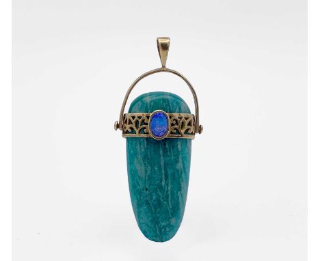 An Egyptian revival style pendant in amazonite, shaped as a stone axe head, it is girdled with a pierced 14ct gold, opal-set 
