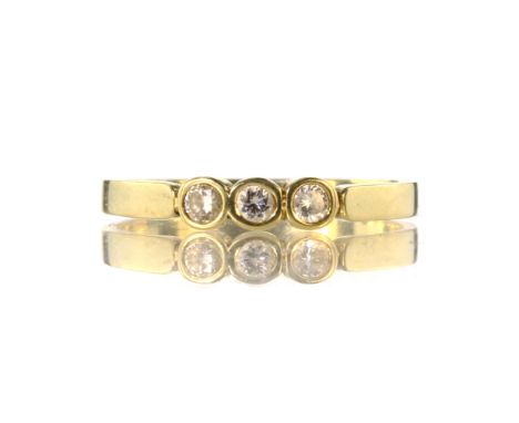 A diamond three stone ring in 18ct yellow gold set with three round cut stones weighing approximately 0.2cts. Ring size O / 7