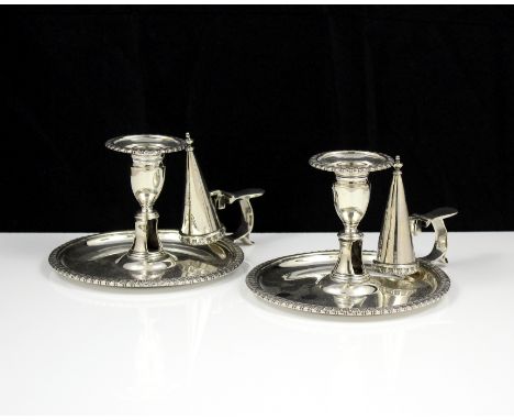 A fine pair of antique George III Sterling Silver chambersticks by John Mewburn, London 1809. Each formed of a candlestick wi