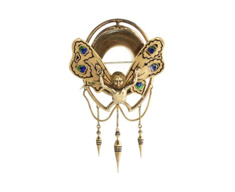 A rare antique enamelled butterfly wing mourning brooch in high carat yellow gold designed as an oval locket filled with hair