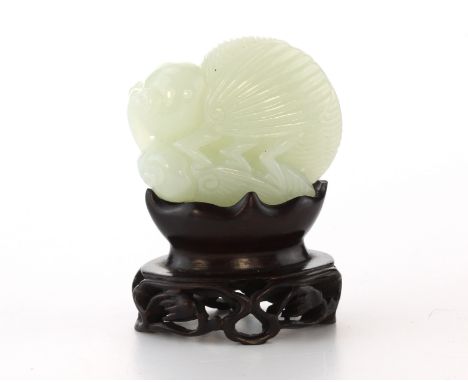 A Chinese green jade carving of mating grasshoppers carved in detail to depict two grasshoppers mating, in a wooden stand. He