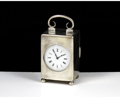 An antique Edwardian Sterling Silver carriage clock by William Comyns, London 1905. Of upright, rounded rectangular form with