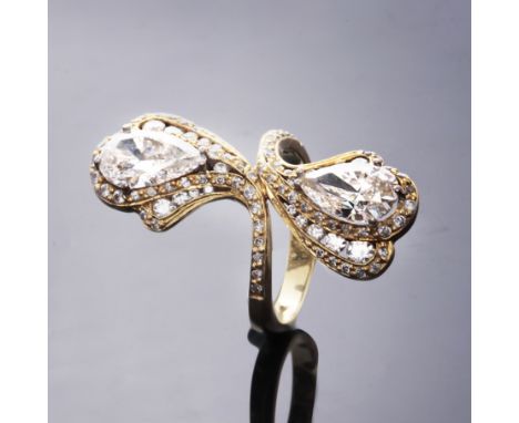 A spectacular diamond dress ring in 18ct yellow gold designed as two pear cut diamonds weighing approximately 1.34cts and 1.4