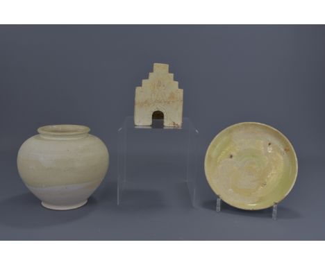 Three pieces of Chinese Tang Dynasty pottery. A white-glazed jar. A lime-glazed dish and a small model of a stove. 8cm, 15cm 