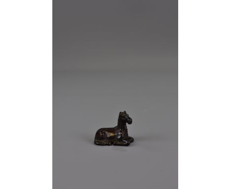 A Japanese 19th century wooden netsuke in the shape of a horse. 5cm