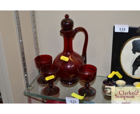Three Bohemian ruby knop stemmed glasses and matching jug 