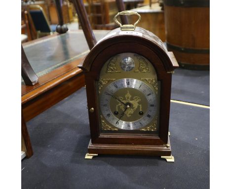 Oak cased brass faced mantel clock raised on brass bracket feet, 26cm in height. Not available for in house P+P.