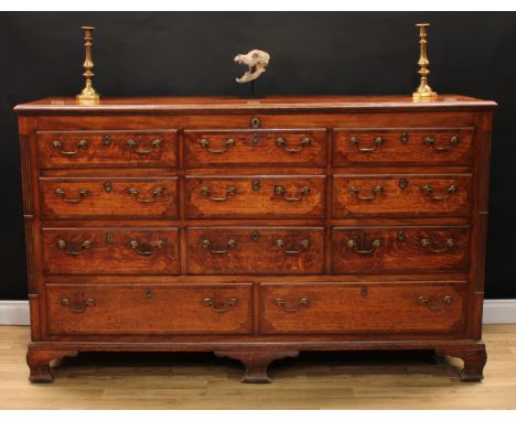 A George III oak and mahogany Lancashire chest, hinged rectangular top with moulded edge enclosing an open till and two small