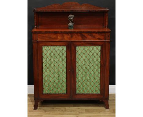A George IV mahogany chiffonier, shaped back with open shelf flanked by turned pillars, the projecting base with drawer to fr