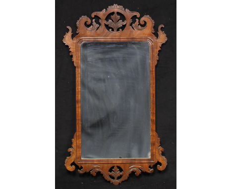 A George III mahogany Vauxhall looking glass, shaped cresting pierced and carved with stiff leaves and flowering C-scrolls, r