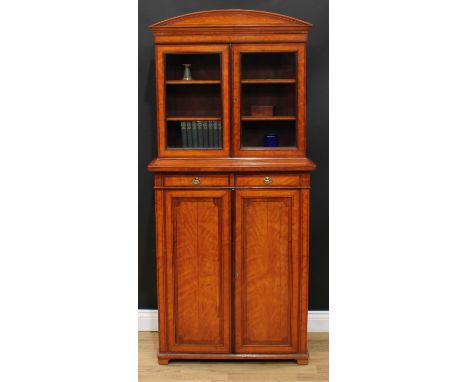 A Sheraton Revival rosewood crossbanded satinwood bookcase, of small and neat proportions, arched cresting above a pair of gl