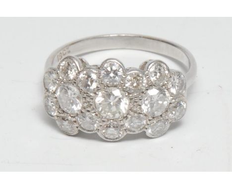 A diamond cluster ring, set with three modern brilliant cut diamonds each approx 0.25ct surrounded by a band of fourteen smal