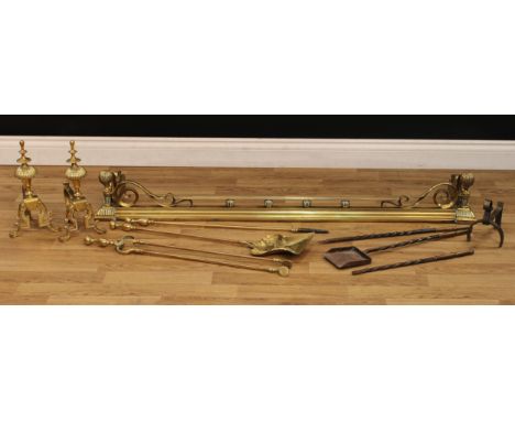 A 19th century brass fire curb or fender, 18cm high, 133.5cm wide, 36cm deep; a pair of andirons; fireside tools (10) 