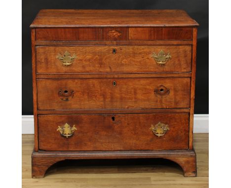 A George III oak chest, slightly oversailing top above a deep mahogany crossbanded frieze centred by a navette-shaped shell p
