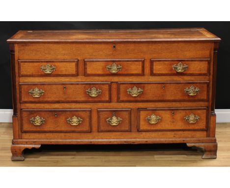 A George III mahogany crossbanded oak Lancashire chest, hinged rectangular top with moulded edge above a row of three blind, 