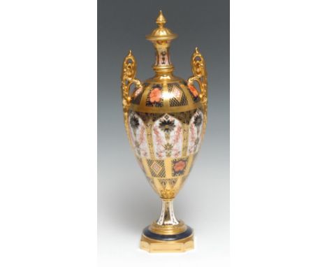 A Royal Crown Derby 1128 pattern pedestal ovoid vase and cover, spire finial, elaborate scroll handles, spreading circular ba