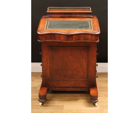 A Victorian walnut Davenport desk, hinged concave rectangular superstructure with three-quarter gallery enclosing stationery 