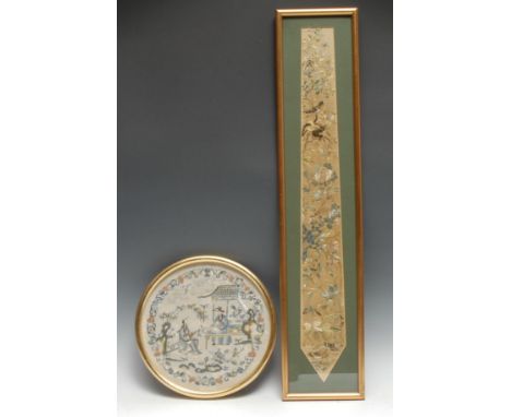 A Chinese circular needlework panel, in silk with an official seated at a table, 22cm diam, Qing Dynasty; a Chinese silk pend