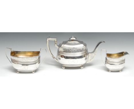 A George III Scottish silver three piece boat shaped tea service, comprising teapot, milk jug and sugar basin, each bright-cu