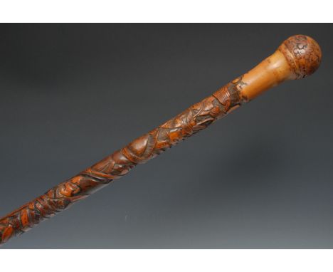 A Japanese bamboo walking stick, well carved with samurai in battle, 87cm long, Meiji period 
