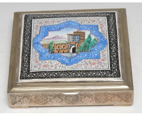 A Persian silver and enamel box, hinged cover decorated in polychrome with an architectural vignette, the sides with dense sc