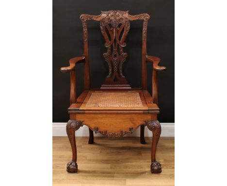 A Chippendale Revival mahogany commode open armchair, shaped cresting rail carved and applied with acanthus, shaped and pierc