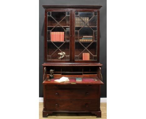 A George III mahogany secretaire bookcase, dentil cornice above a pair of astragal glazed doors enclosing two adjustable shel